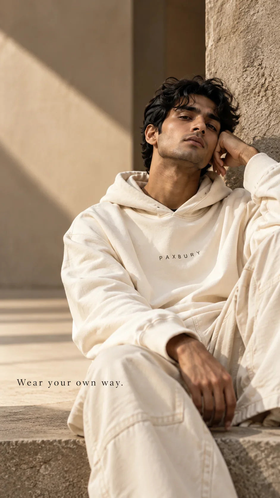PAXBURY styling concept: portrait of a model in a light ivory oversized hoodie