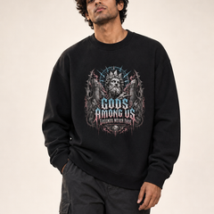 Indian male model front hero wearing PAXBURY Gods Among Us black UH35 oversized unisex crewneck sweatshirt; illustrated crowned stone god and vintage gothic typography centred on chest