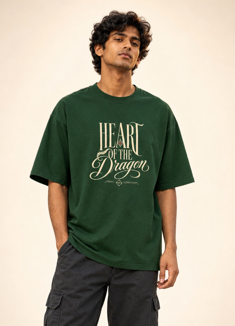 Indian male model wearing PAXBURY Heart of the Dragon bottle green UC22 relaxed cotton oversized T-shirt with cream HEART OF THE Dragon typographic front print