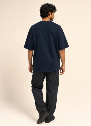 Indian male model showing completely plain navy back of PAXBURY Somewhere Beyond roomy unisex 240 GSM T-shirt