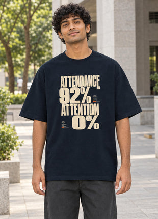 Indian male wearing navy Attendance 92% Attention 0% oversized T-shirt with bold cream print on front