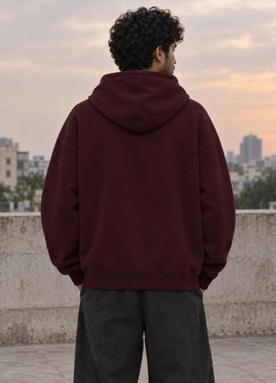 Indian male model showing completely plain back of maroon Buffering Offbeat UH32 oversized hoodie