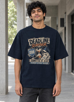 Indian male wearing Deadline Survivors navy oversized T-shirt with original-inspired hourglass illustration and distressed cream and orange front lettering