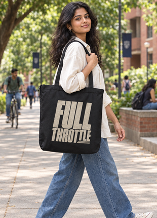 Black Full Throttle zipped tote worn by a young Indian female college student outdoors, graphic front