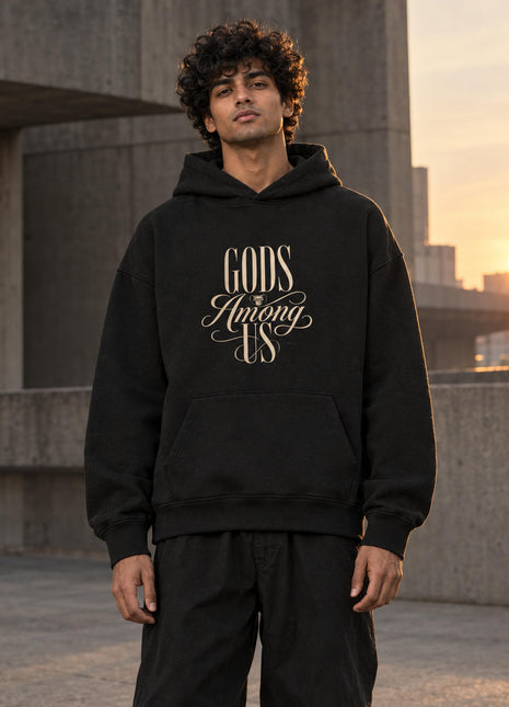 PAXBURY Gods Among Us black oversized hoodie on Indian male model, cream GODS Among US typographic front print