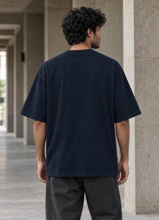 Indian male model back view showing completely plain navy blue oversized T-shirt