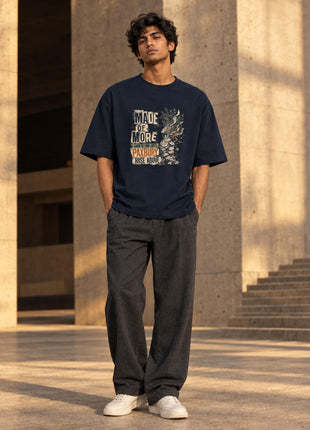Indian male styling view of Made of More navy oversized graphic T-shirt with original-inspired distressed artwork