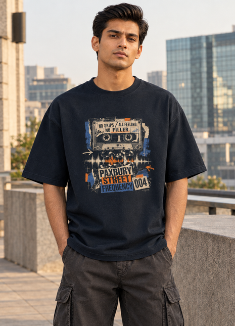 Kittl-made PAXBURY No Skips navy oversized UC22 T-shirt on Indian male model; correct original front cassette art in rooftop city scene