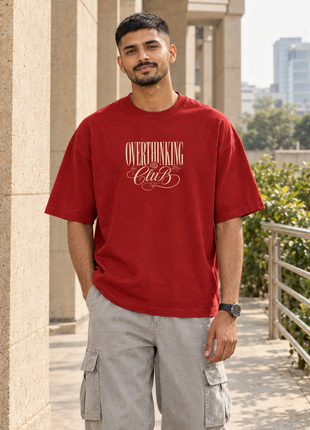 Kittl Indian male front wearing PAXBURY Overthinking Club red oversized UC22 T-shirt with correct small cream script front graphic