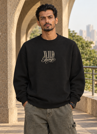 Kittl male front editorial wearing PAXBURY Wild Things black oversized UH35 sweatshirt with original compact cream WILD Things lettering