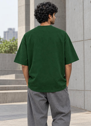 Plain bottle-green unprinted back on Indian male model, PAXBURY oversized cotton T-shirt