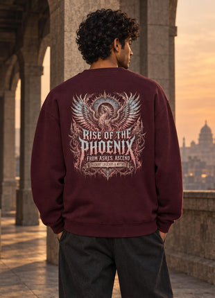 Indian male model wearing maroon oversized Rise of the Phoenix sweatshirt with large illustrated phoenix and gothic print on back