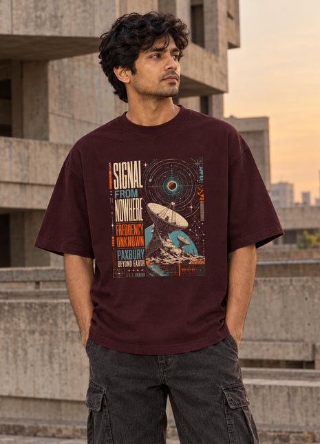 Indian male model wearing maroon Signal From Nowhere oversized T-shirt with original-inspired signal and satellite-dish front graphic