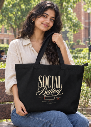 Social Battery large black zipped tote elegant front print — Indian university student seated outdoors