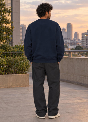 Rear view of Indian male model wearing Social Battery navy oversized sweatshirt, entirely unprinted back