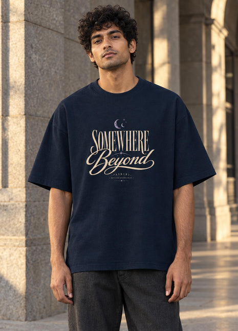 Indian male model wearing PAXBURY Somewhere Beyond navy oversized T-shirt, front graphic fully visible