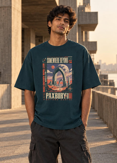 Indian male model wearing PAXBURY Somewhere Beyond petrol-blue oversized tee with retro-futurist front graphic