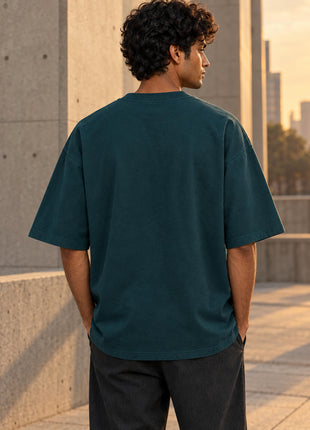 Indian male model showing plain unprinted petrol-blue back of Somewhere Beyond UC22 T-shirt